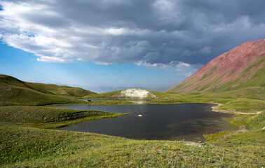 lake in the mountains with storm clouds and dramatic sky 