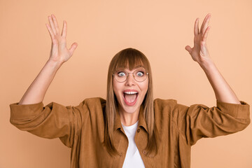 Photo of astonished cheerful young lady raise hands shocked discount shopping isolated on pastel...