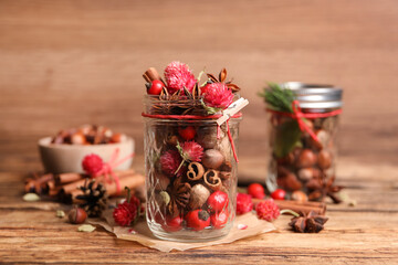 Aromatic potpourri in glass jar on wooden table