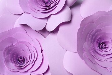 Beautiful violet flowers made of paper as background, top view