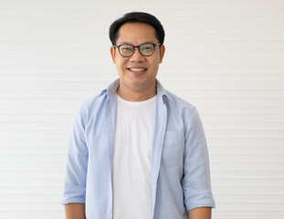 Portrait of Asin man wearing eyeglasses standing with self-confident and friendly-looking