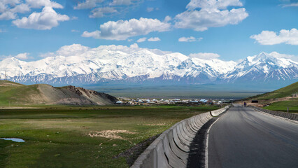 panoramic landscape of road going to high peak mountain range 