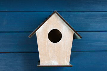 Obraz na płótnie Canvas Beautiful bird house on blue wooden table, top view