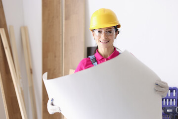 Woman architect holding building construction project in hands. Infrastructure planning concept