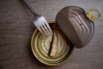 Fork on sprat can with only one depresive sprat in can.