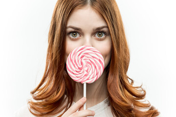 woman with lollipop in her hands red hair enjoyment fun