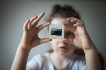 Young girl child looking at vintage retro slide