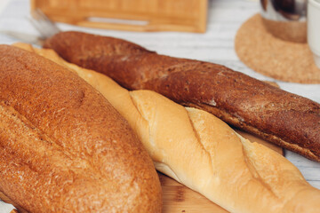 fresh loaves on a breadbasket on the table breakfast kitchen meal