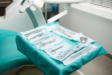 dentists work tray, individually packaged surgical materials, dental clinic background