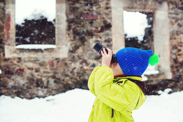 Child walking around old castle. Little boy discovery intresting things during using monocular.