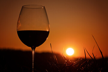 glass of red wine at sunset 