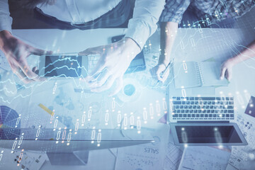 Double exposure of man and woman working together and financial chart hologram drawing. market analysis concept. Computer background. Top View.