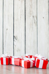 Fototapeta na wymiar Red gift boxes on white wooden floor