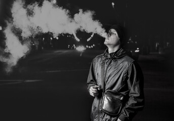 The guy in the jacket exhales steam on the street, black and white photo