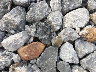 Fototapeta na wymiar The background image of gray rocks is random stacked beautifully.