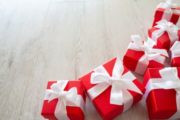 Red gift boxes on white wooden floor