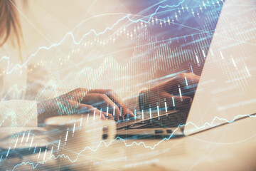 Double exposure of woman hands working on computer and forex graph hologram drawing. Financial analysis concept.