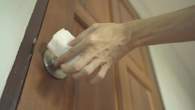 Spray alcohol on door knob and wipe with tissue paper
