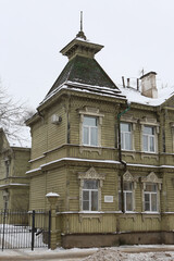 Ancient wooden house with ornamental windows, carved frames of merchant Sapozhnikov on Simanovsky...