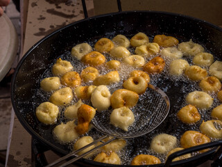 frying pan with mallorquin traditional sweet dish called bunyols, majorca, spain
