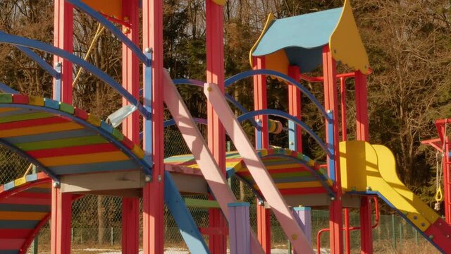 playground near the forest children during quarantine. surgery mask waving on a wind