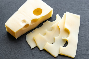 Gouda cheese on gray background. Gouda cheese slices