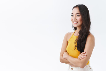 Lifestyle, beauty and emotions concept. Cheerful, self-assured young east-asian woman in yellow...