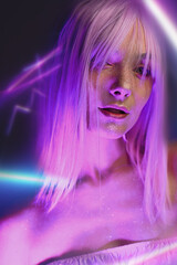 A girl with pink hair and beautiful makeup is surrounded by neon light 

 