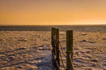 Floating ice on the Wadden Sea at sunrise near 't Kuitje, Den Helder, Netherlands.