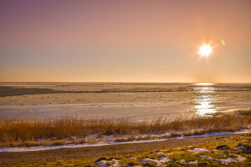 Floating ice on the Wadden Sea at sunrise near 't Kuitje, Den Helder, Netherlands.