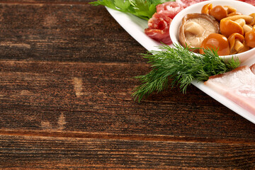 Naklejka na ściany i meble Pickled mushrooms on a plate with dill. Copy space