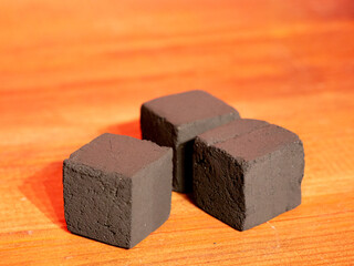 Hookah for smoking that consists of a small container or bowl, where chopped tobacco is burned, attached to a tube ending in a mouthpiece, through which the smoke is inhaled. on platform with red lase