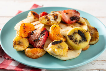 GRILLED FRUIT on a blue plate and white wooden background