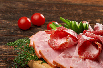 Ham on a wooden board still life on a wooden natural background.