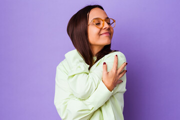 Young mixed race woman isolated hugs, smiling carefree and happy.