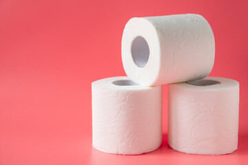 Toilet paper on pink background