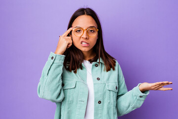 Young mixed race woman isolated showing a disappointment gesture with forefinger.