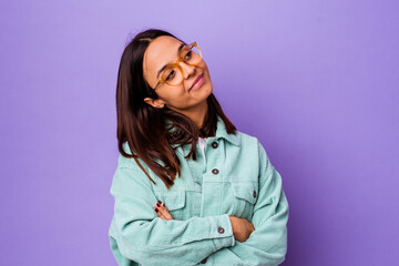 Young mixed race woman isolated dreaming of achieving goals and purposes