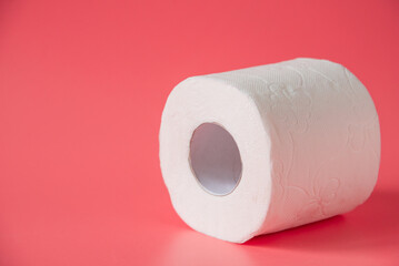 Toilet paper on pink background