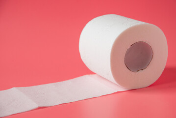 Toilet paper on pink background