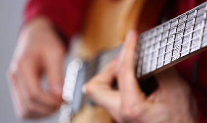 Man playing musical instrument guitar closeup. School of music concept