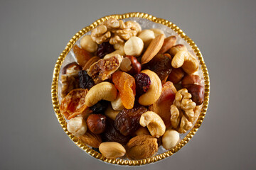 Mixed nuts in a glass plate. Healthy and natural nutrition .Cashew, Almond,, Hazelnut,, Fig,, Walnut,, Apricot,, Raisin,, Blueberry.
