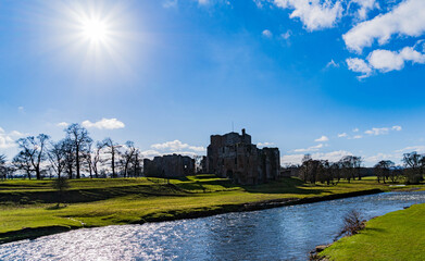 Fototapeta na wymiar Sun shining over Brougham Castle and the river Eamont