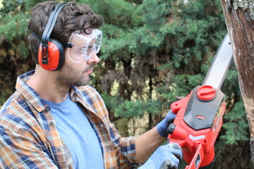 Naklejka premium Candid of lumberjack holding a chainsaw