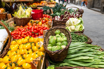 Broccoli, zucchini, green beans, brussels sprouts and red tomatoes in baskets at local farmer's market . Healthy food eating organic vegetables. selective focus