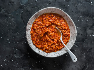 Vegetarian cauliflower cabbage bolognese sauce on dark background, top view