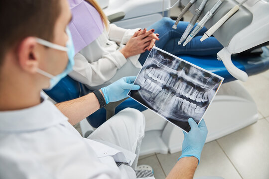Dental specialist looking at x-ray of teeth