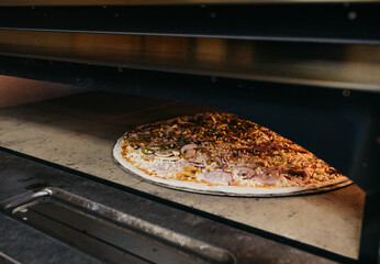 A pizza in a oven burning. Before baking. Cooking process