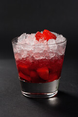 Strawberry cocktail with crushed ice on a red gradient
