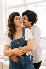 Affectionate lesbian couple indoors